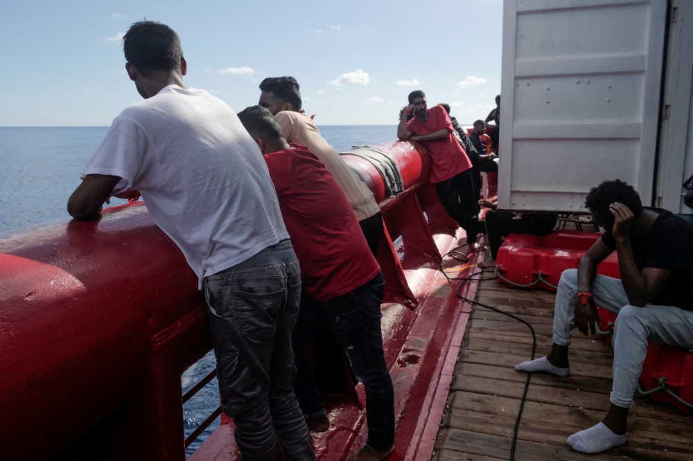 Migrants stand on deck of NGO rescue ship 'Ocean Viking', in the Mediterranean Sea, on November 8, 2022. Camille Martin Juan/Sos Mediterranee/Handout via REUTERS