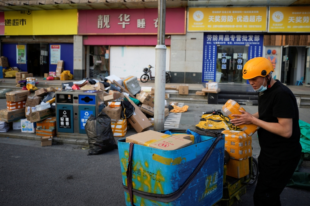 A delivery worker sorts parcels at a makeshift logistics station ahead of Alibaba's Singles' Day shopping festival, following the coronavirus disease (COVID-19) outbreak in Shanghai, China, November 10, 2022. Reuters/Aly Song