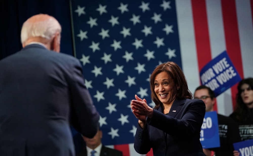 US Vice President Kamala Harris applauds President Joe Biden during an event hosted by the Democratic National Committee to thank campaign workers, at Howard Theatre in Washington, DC, November 10, 2022. (Photo by Mandel NGAN / AFP)