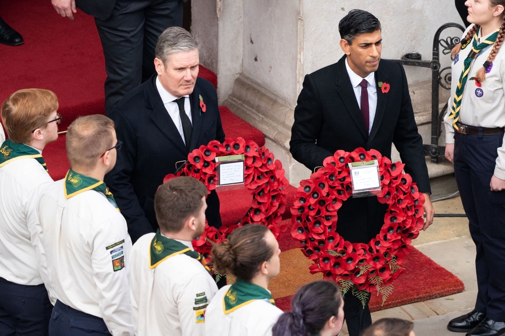 Britain's main opposition Labour Party leader Keir Starmer (left) and Britain's Prime Minister Rishi Sunak come out to lay wreaths at The Cenotaph during the Remembrance Sunday ceremony on Whitehall in central London, on November 13, 2022.  (Photo by Stefan Rousseau / POOL / AFP)