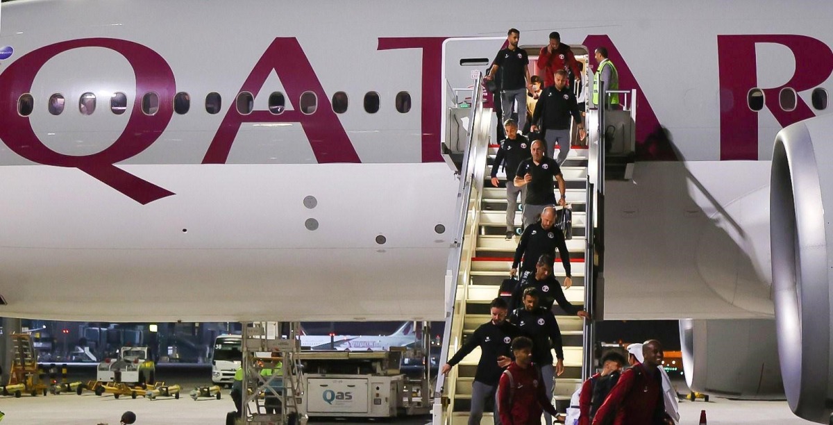 Qatar players and officials arrive in Doha on a Qatar Airways flight.