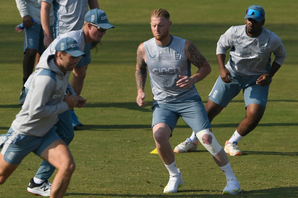 England captain Ben Stokes (2R) warms during a training session.  Photo by Aamir QURESHI / AFP)