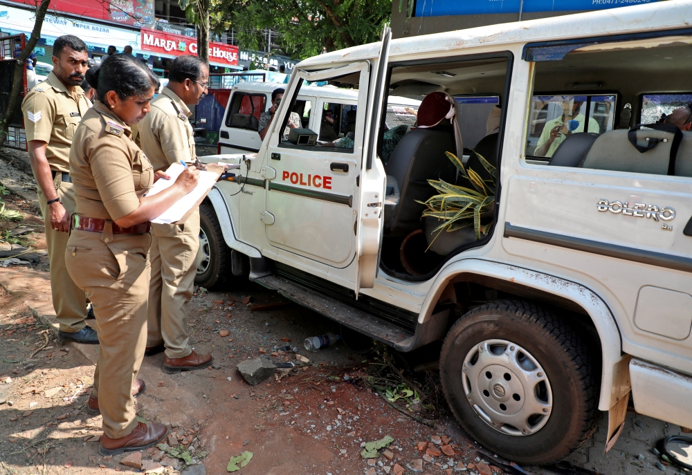 Police officers examine a vehicle that was damaged during a clash with protesters at a police station near the proposed Vizhinjam Port in the southern state of Kerala, India, November 28, 2022. REUTERS/Stringer