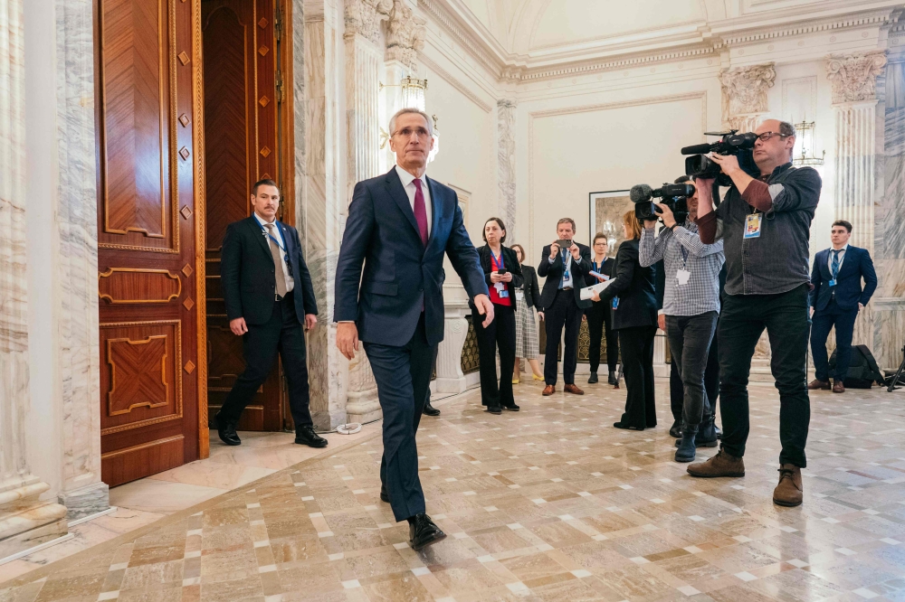 NATO Secretary General Jens Stoltenberg arrives for a press conference during a meeting of the NATO Ministers of Foreign Affairs, joined by the Ministers of Foreign Affairs of Finland, Sweden and Ukraine, as well as the EU High Representative for Foreign Affairs and Security Policy, at the Palace of the Parliament of Romania in Bucharest, on November 30, 2022. (Photo by Andrei Pungovschi / AFP)
 