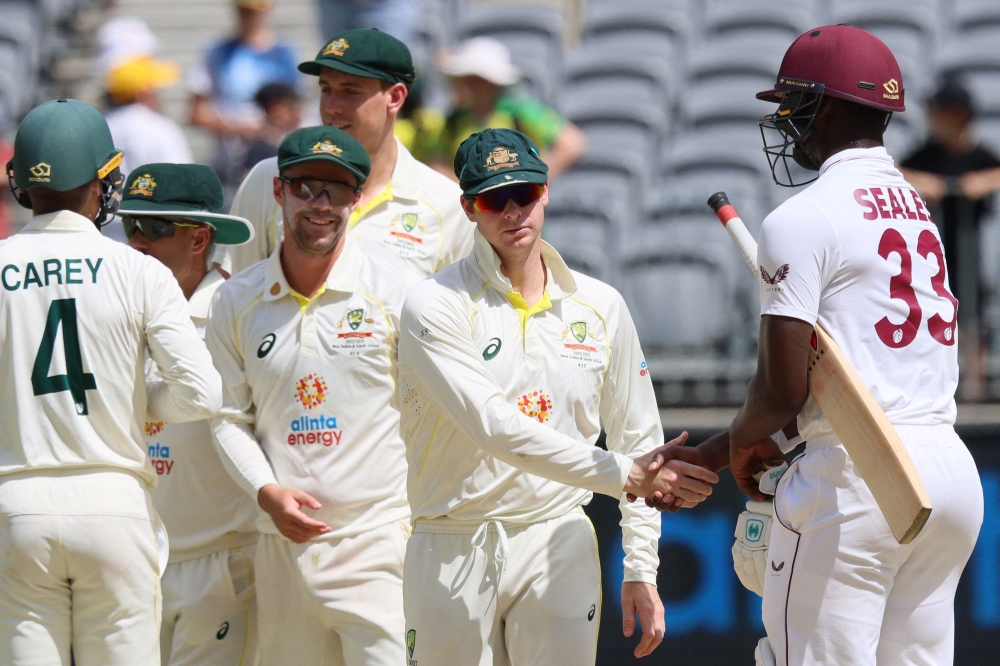 West Indies' batsman Jayden Seales (R) shakes hands with Australia's Steve Smith (C) after Australia won the first Test cricket match against the West Indies at Perth Stadium on December 4, 2022. (Photo by Trevor Collens / AFP)