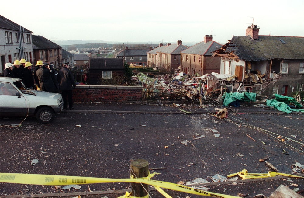 In this file photo taken on December 22, 1988 policemen and firemen look at the scene of devastation in Lockerbie, after a 747 Pan Am Jumbo jet exploded and crashed over the town the day before on the route to New-York, with 259 passengers on board. (Photo by ROY LETKEY / AFP)
