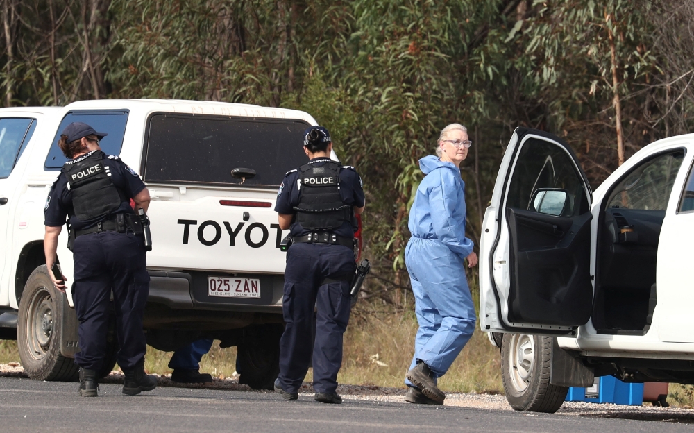Police work near the scene of a fatal shooting, where police shot multiple people at a remote Queensland property after an ambush in which two officers and a bystander were also killed, in Wieambilla, Australia, December 13, 2022. AAP Image/Jason O'Brien via REUTERS 