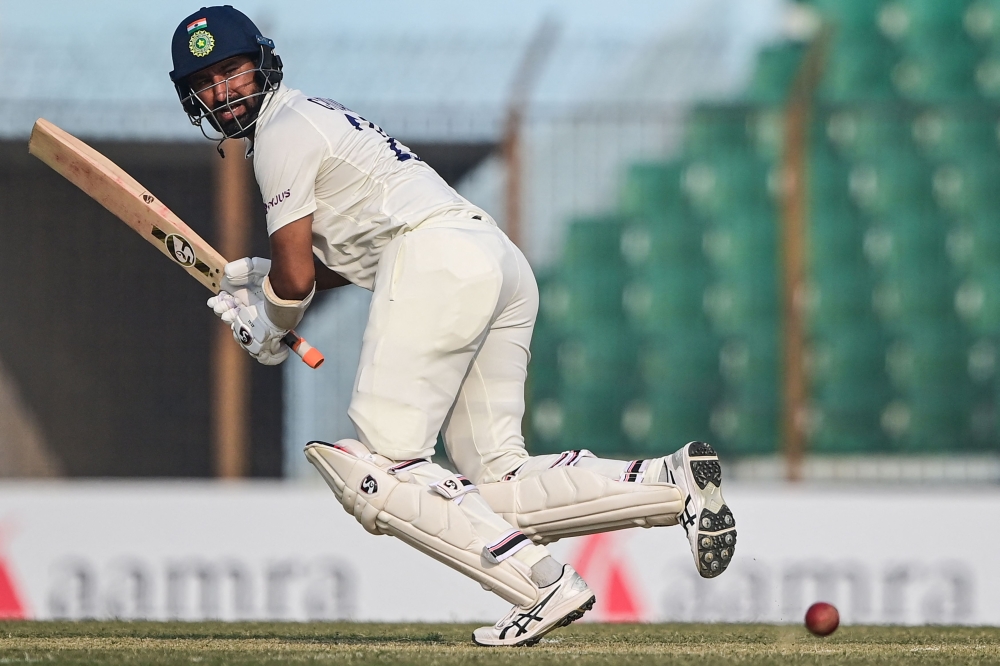 India's Cheteshwar Pujara plays a shot during the first day of the first cricket Test match between Bangladesh and India at the Zahur Ahmed Chowdhury Stadium in Chittagong on December 14, 2022. (Photo by Munir uz Zaman / AFP)