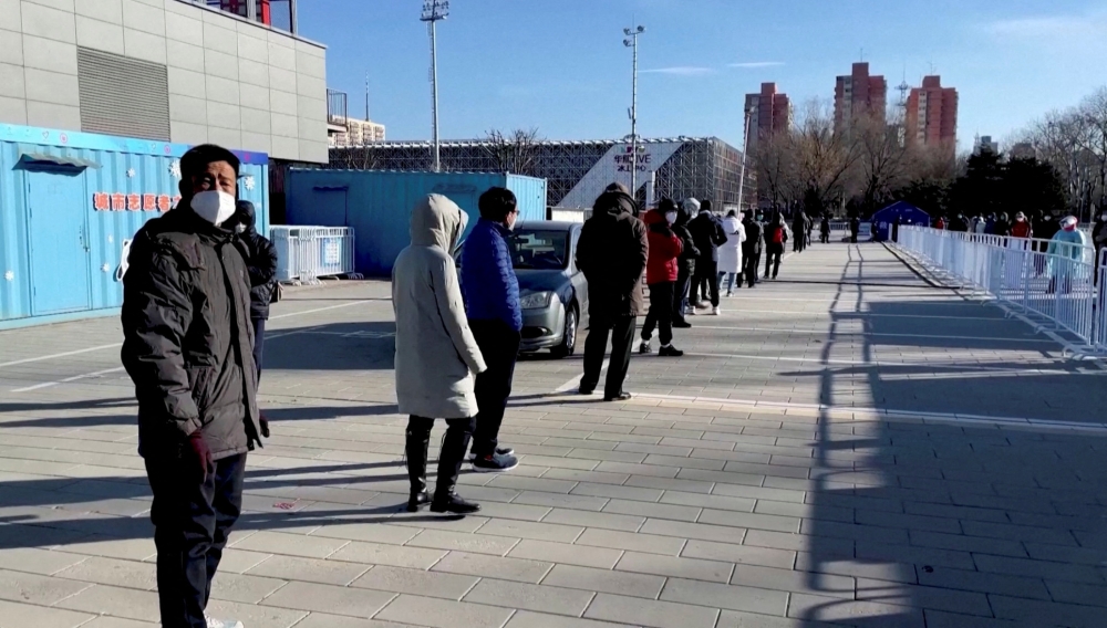 Residents queue to receive a nasal spray COVID-19 booster vaccine in Beijing, China December 17, 2022 in this still image obtained from a video. Reuters TV/via Reuters 