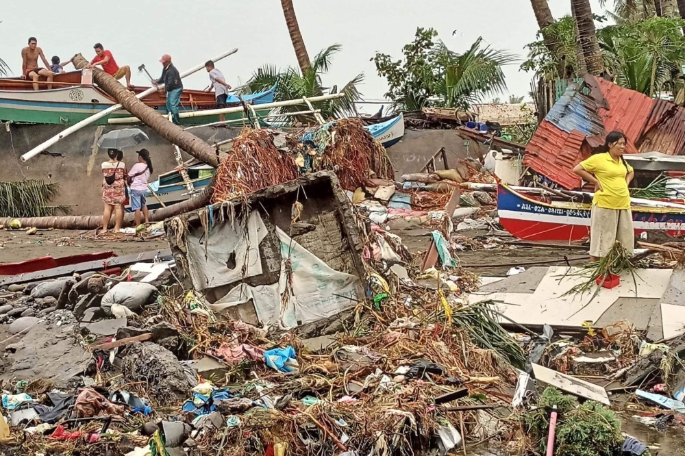 This handout photo courtesy of Angelica Villarta taken on December 27, 2022 and received on December 28 shows residents surveying damage caused by heavy rain and floods in Oroquieta City, Misamis Occidental. (Photo by Handout / Angelica Villarta / AFP) 