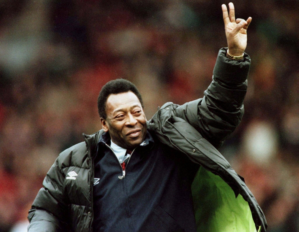 Brazilian soccer legend Pele greets the crowd at the Manchester United versus Liverpool match during the half time interval in Manchester, Britain, April 10, 1998. REUTERS/Ian Hodgson//File Photo

