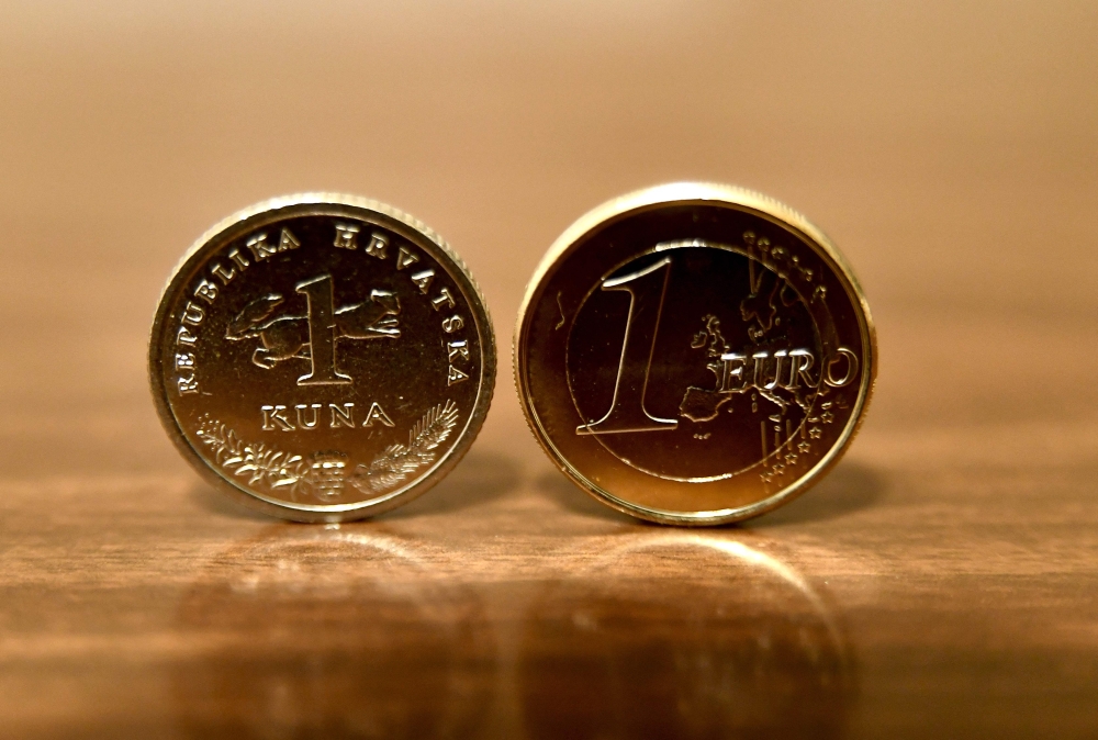 A photograph shows one Kuna and one Euro coins in Zagreb on December 30, 2022. (Photo by Denis LOVROVIC / AFP)