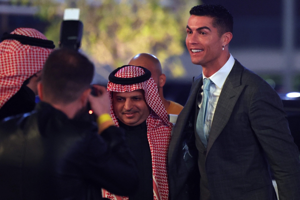 Portuguese forward Cristiano Ronaldo (right) greets President of Al-Nassr Musalli Al-Muammar upon his arrival at the Mrsool Park Stadium in the Saudi capital Riyadh on January 3, 2023, ahead of the unveiling ceremony. (Photo by Fayez Nureldine / AFP)