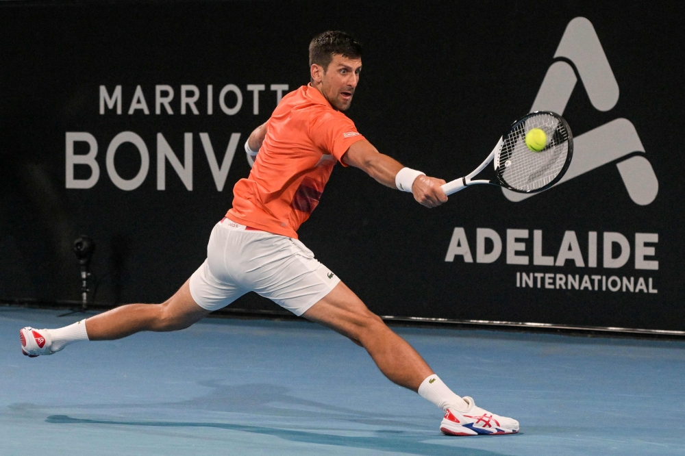 Serbia's Novak Djokovic hits a return against Canada's Denis Shapovalov during their men's singles quarter-final match at the Adelaide International tennis tournament in Adelaide on January 6, 2023. (Photo by Brenton EDWARDS / AFP)