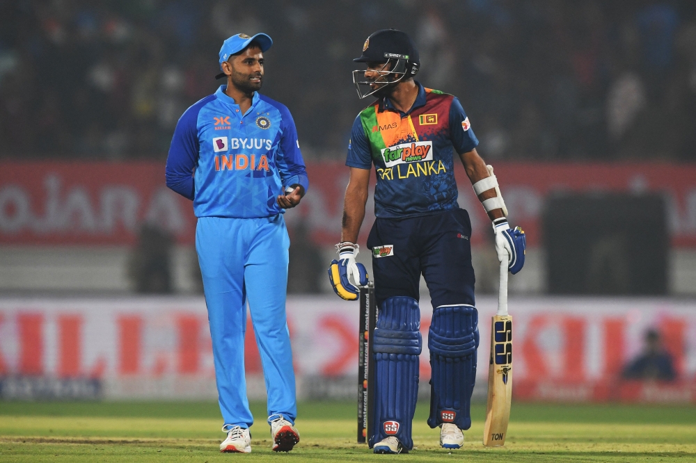 India's Suryakumar Yadav (left) talks with Sri Lanka's captain Dasun Shanaka during the third Twenty20 international cricket match between India and Sri Lanka at the Saurashtra Cricket Association Stadium in Rajkot on January 7, 2023. (Photo by INDRANIL MUKHERJEE / AFP)