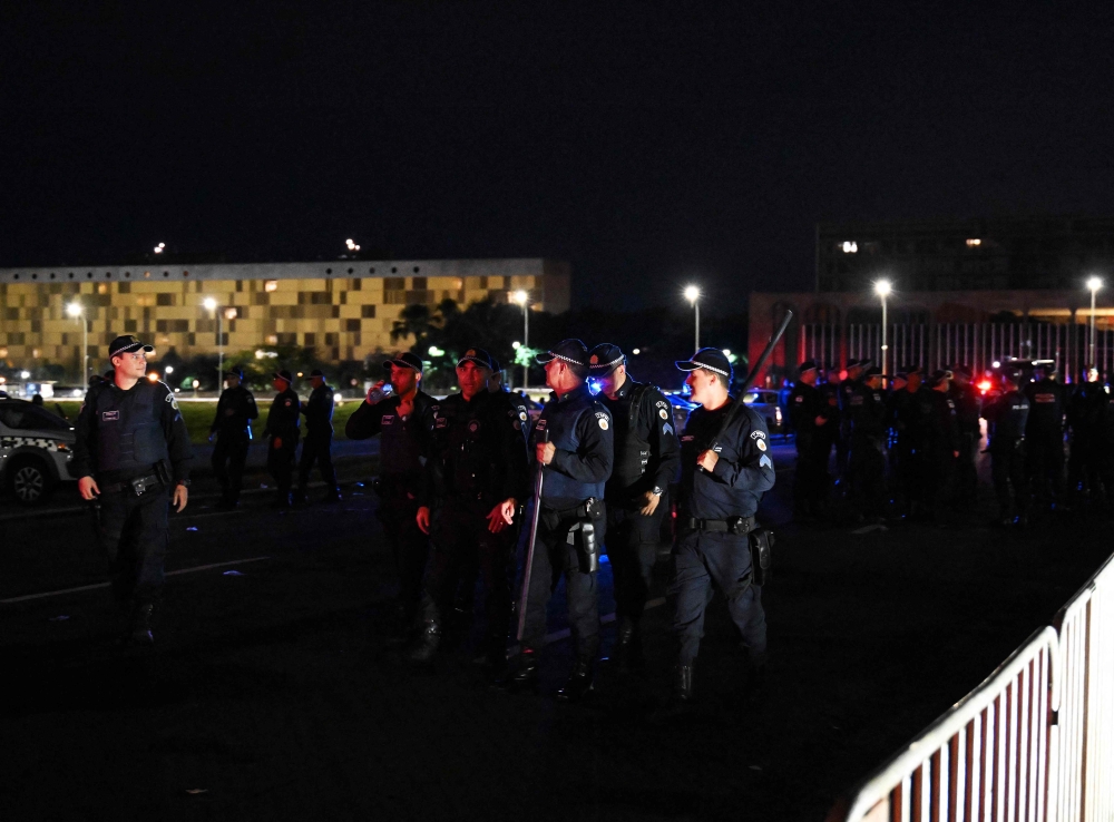 Military police gather at Congress after it was invaded by supporters of former Brazilian President Jair Bolsonaro, in Brasilia on January 9, 2023. (Photo by Carl De Souza/ AFP)