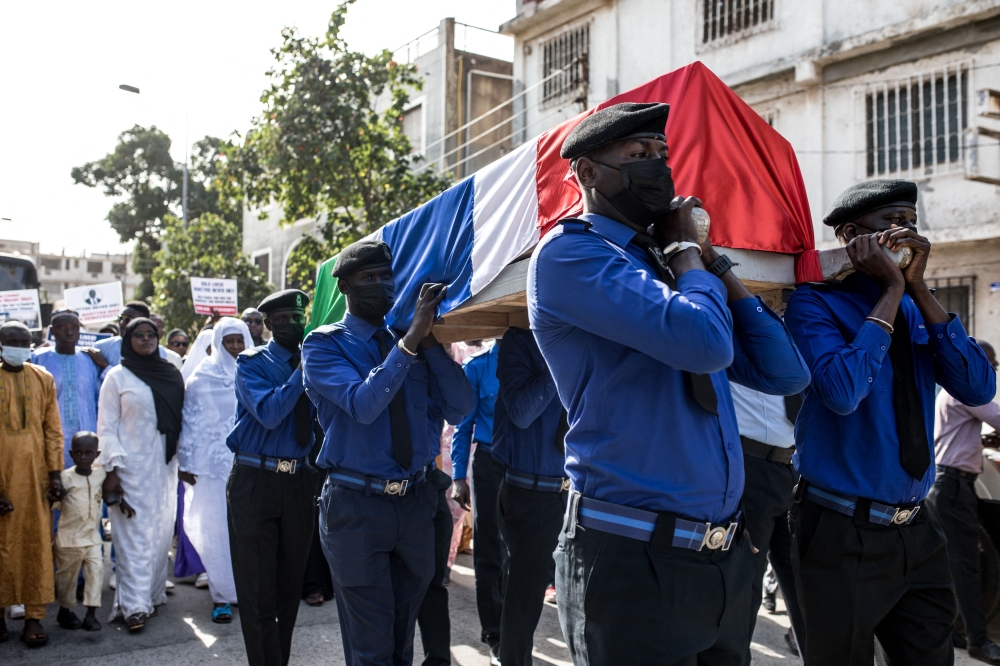 Pallbearers carry the coffin of Solo Sandeng during his funeral in Banjul on January 10, 2023. (Photo by Muhamadou BITTAYE / AFP)