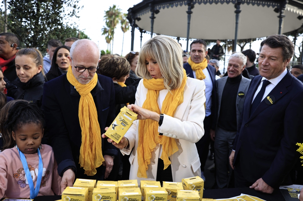French President's wife Brigitte Macron (centre) and Nice Mayor Christian Estrosi (right) attend the opening of the 2023 edition of the 