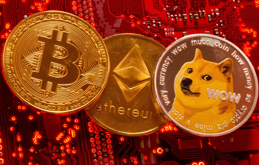 Representations of Cryptocurrencies Bitcoin, Ethereum and DogeCoin are placed on PC motherboard in this illustration taken, June 29, 2021. (REUTERS/Dado Ruvic)