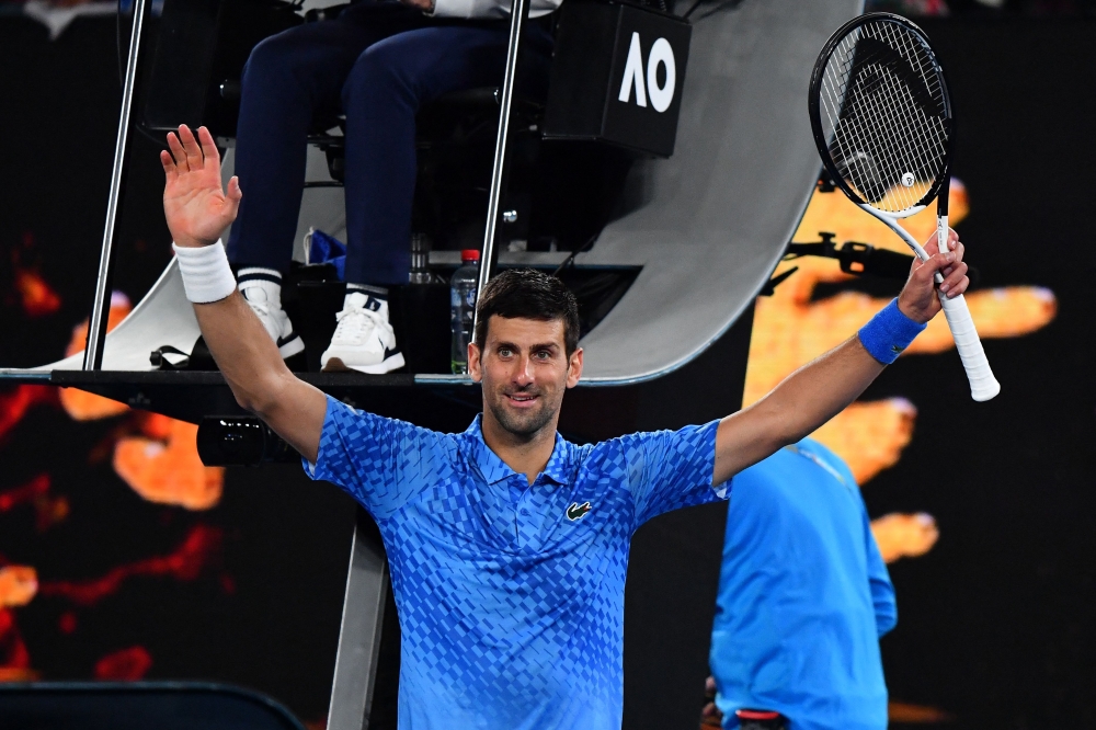 Serbia's Novak Djokovic celebrates after winning against Spain's Roberto Carballes Baena during their men's singles match on day two of the Australian Open tennis tournament in Melbourne early on January 18, 2023. (Photo by Paul CROCK / AFP) 