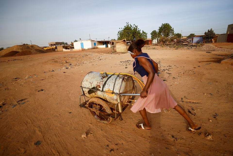 A woman pushes a barrel filled with water on the outskirts of Ouagadougou, Burkina Faso on January 30, 2022. File Photo / Reuters
