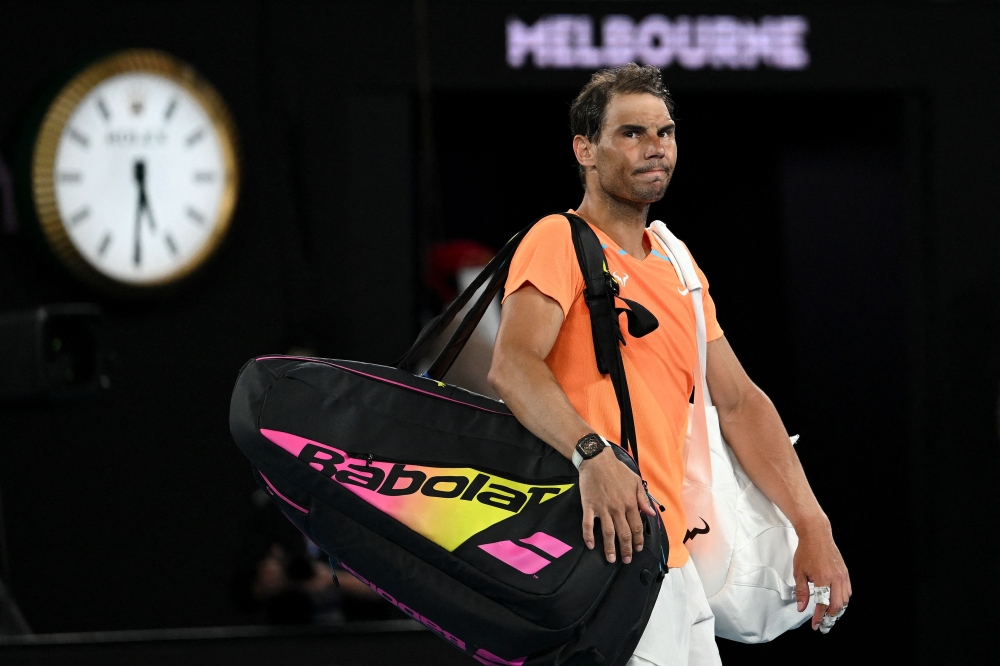 Spain's Rafael Nadal leaves the court after losing to USA's Mackenzie McDonald in their men's singles match on day three of the Australian Open tennis tournament in Melbourne on January 18, 2023. (Photo by MANAN VATSYAYANA / AFP) 