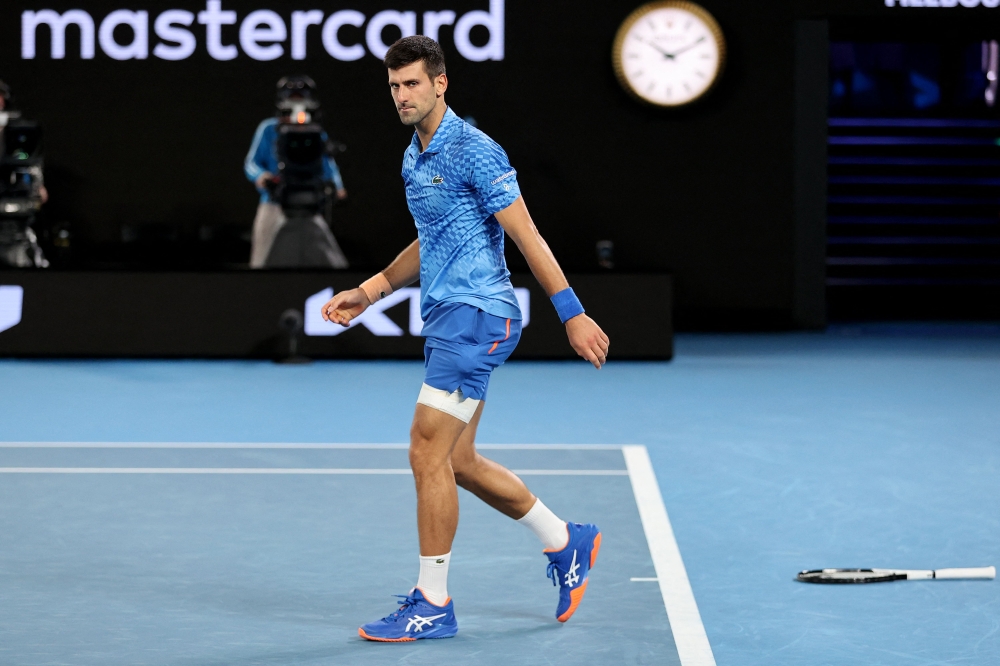 Serbia's Novak Djokovic reacts as he competes against Bulgaria's Grigor Dimitrov during their men's singles match on day six of the Australian Open tennis tournament in Melbourne on January 21, 2023. (Photo by Martin KEEP / AFP)