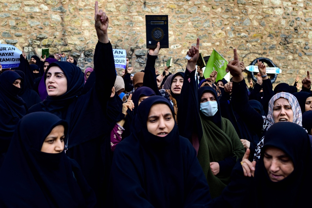 Protesters gather in front of the Consulate General of Sweden in Istanbul on January 22, 2023, after Rasmus Paludan, leader of Danish far-right political party burned a copy of the Holy Quran near the Turkish Embassy in Stockholm. (Photo by Yasin Akgul / AFP)