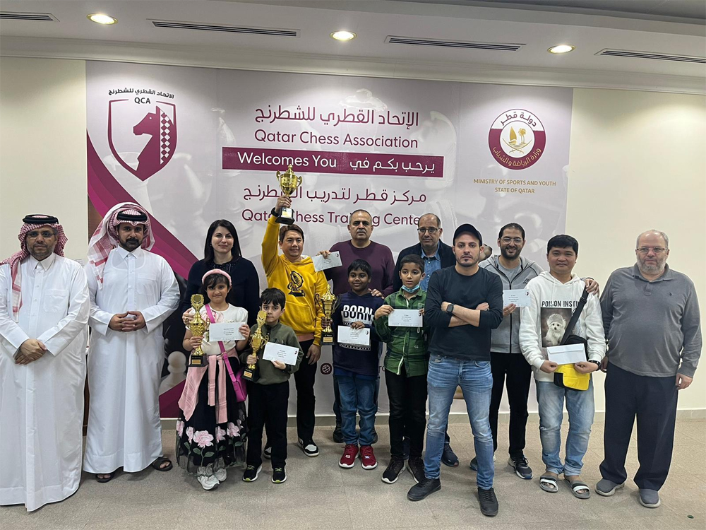 Loyola Rawlinson of the Philippines lifts the trophy as participants and officials pose for a photo after presentation ceremony.  