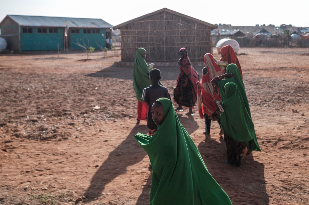 Children walk at a school in the camp for internally displaced people of Farburo in the village of Adlale, near the city of Gode, Ethiopia, on January 11, 2023. - The last five rainy seasons since the end of 2020 have failed, triggering the worst drought in four decades in Ethiopia, Somalia and Kenya. And the next rainy season, from March to May, is also expected to be below average. According to the UN, drought has plunged 12 million people into 