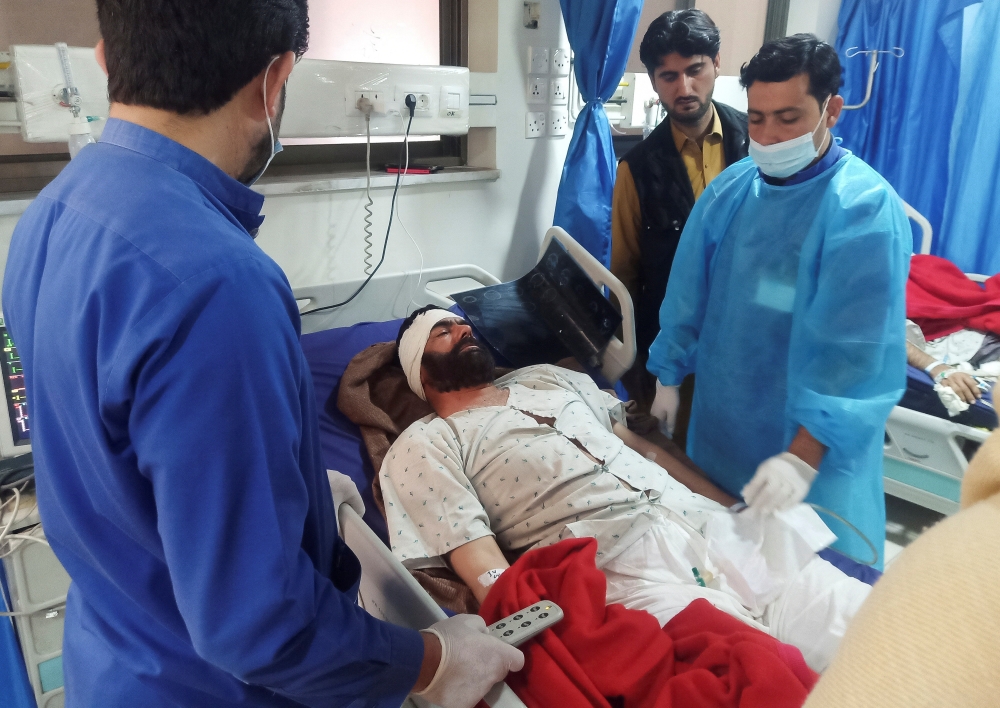 A man, injured after a suicide blast in a mosque, receives medical aid at a hospital in Peshawar, Pakistan January 31, 2023. REUTERS/Fayaz Aziz