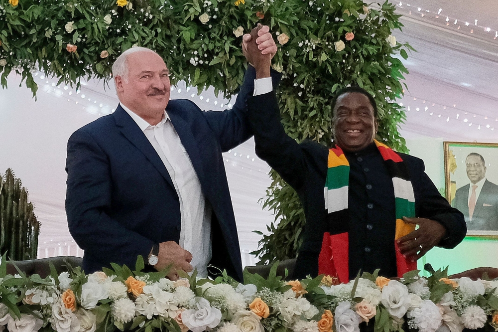 Belarus President Alexander Lukashenko (left) with Zimbabwean President Emmerson Mnangagwa upon his arrival at State House in Harare, Zimbabwe, on January 31, 2023 after a signing ceremony of bilateral agreements for economic cooperation between the two countries. (Photo by Jekesai Njikizana / AFP)