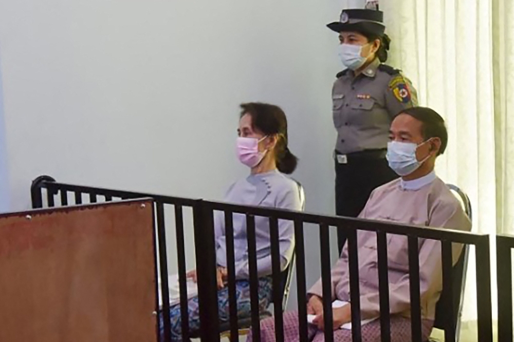 In this file handout photo taken on May 24, 2021 and released by Myanmar's Ministry of Information on May 26 shows detained civilian leader Aung San Suu Kyi (left) and detained president Win Myint during their first court appearance in Naypyidaw, since the military detained them in a coup on February 1. ( Handout / Myanmar Ministry of Information / AFP)