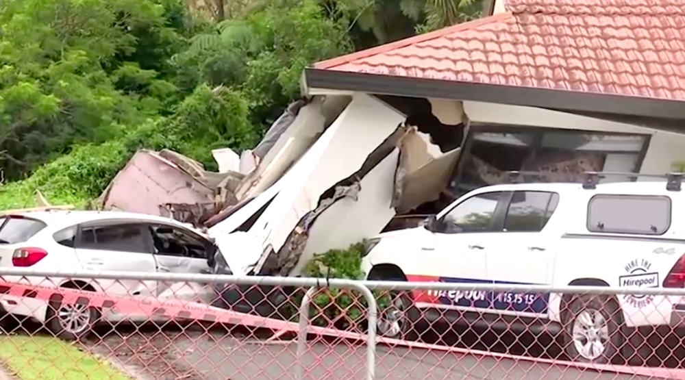 A view of a house that had collapsed on vehicles, following floods, in Auckland, New Zealand, January 30, 2023 in this screen grab obtained from video. (Newshub/via Reuters)