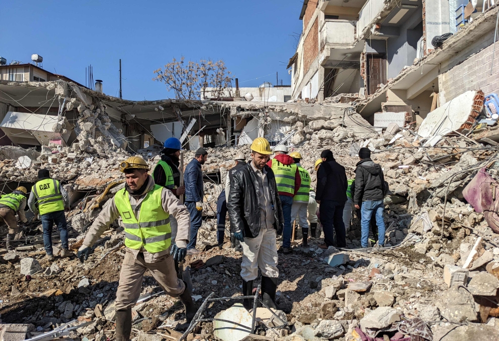 Turkish Hard Coal Enterprises (TTK) miners from Zonguldak take part in search operations in Antakya, on February 9, 2023, three days after a 7,8-magnitude earthquake struck southeast Turkey. (Photo by Remi BANET / AFP)