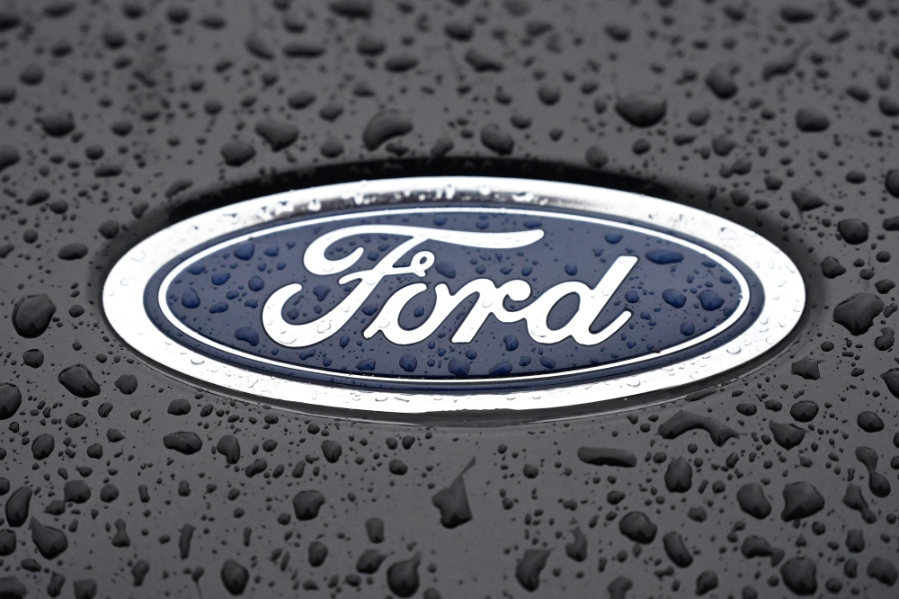 This file photograph taken on October 18, 2021, shows the Ford logo on the front of a vehicle at the company's Halewood plant in Liverpool, north-west England. Photo by Paul ELLIS / AFP

