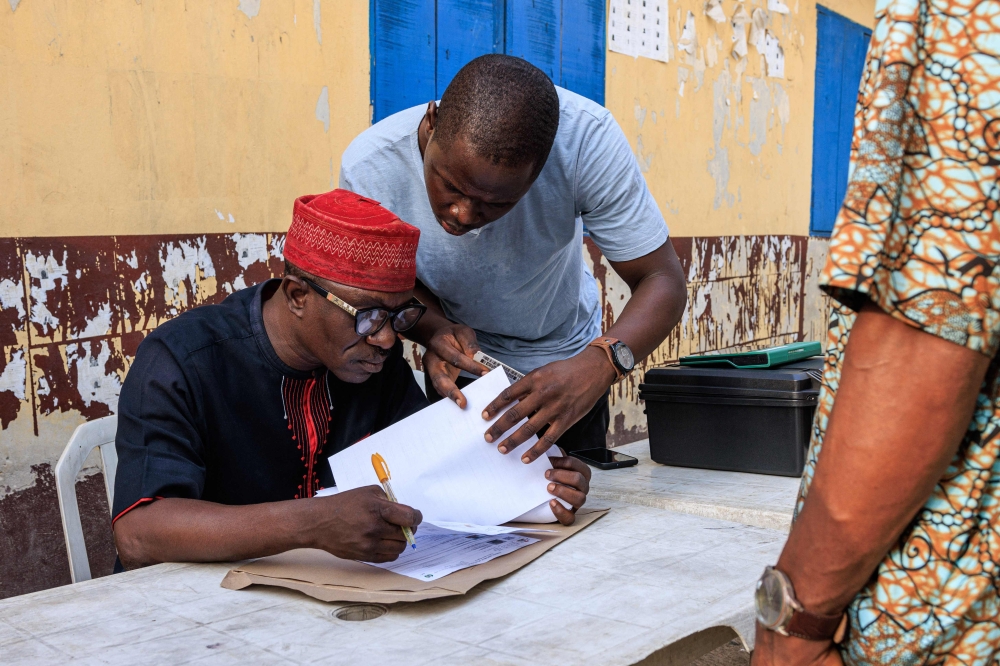 File photo: Independent National Electoral Commission (INEC) officials verify voters during a mock accreditation exercise organised by the INEC at Enitan Primary School at Surulere in Lagos, Nigeria, on February 4, 2023. (Photo by Benson Ibeabuchi / AFP)

