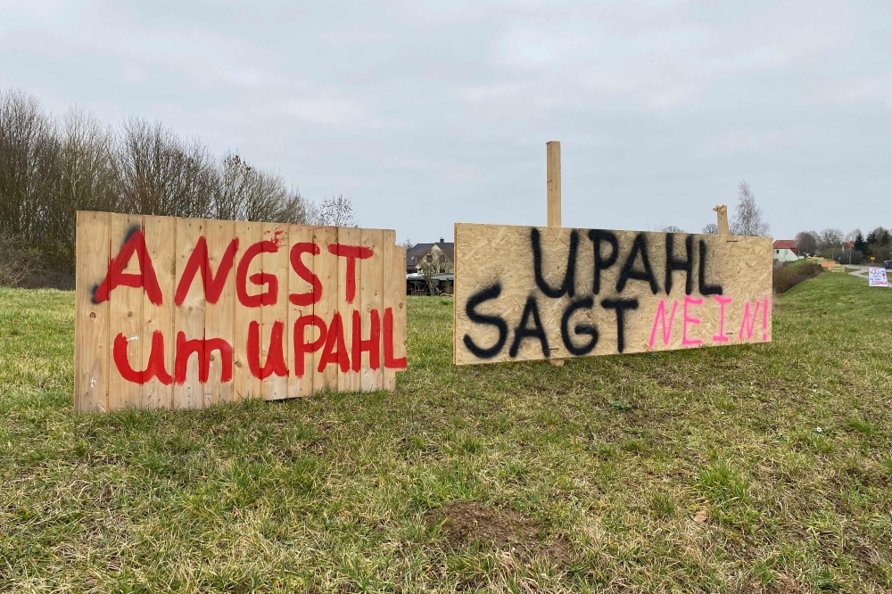 Placards reading 'Afraid for Upahl' (L) and 'Upahl says no' are displayed along the main road passing through Upahl, northern Germany on February 13, 2023.