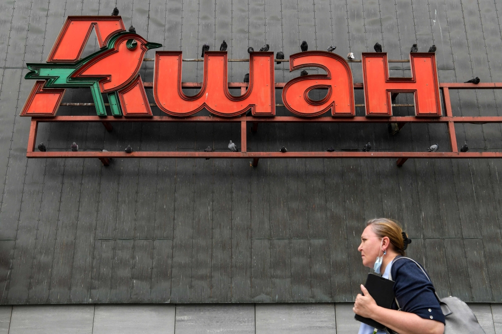 In this file photo taken on August 03, 2020, the logo of French supermarket Auchan is pictured on the wall of a shopping mall in Moscow on August 3, 2020.  (Photo by Kirill Kudryavtsev / AFP)