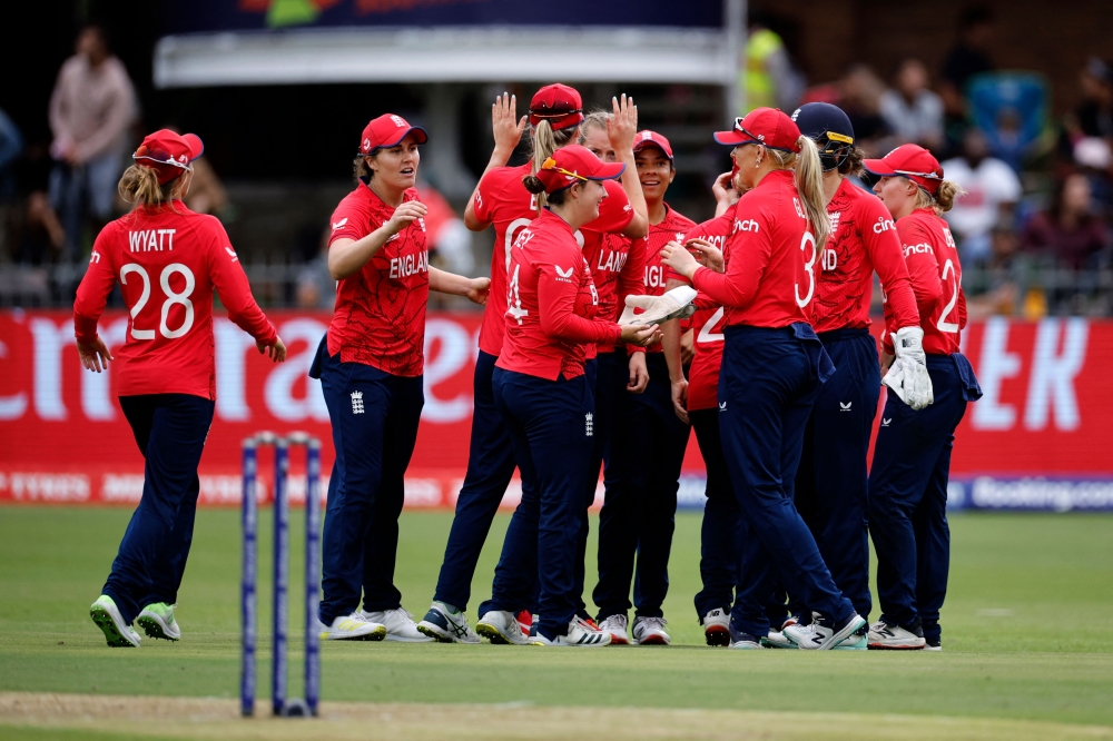 England players celebrate the dismissal of India's Harmanpreet Kaur (not seen) during the Group B T20 women's World Cup cricket match between England and India at St George's Park in Gqeberha on February 18, 2023. (Photo by Marco Longari / AFP)