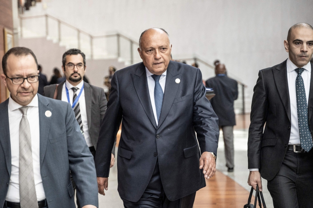 Egypt's Foreign Minister Sameh Shoukry (center) arrives on the second day of the 36th Ordinary Session of the Assembly of the African Union (AU) at the Africa Union headquarters in Addis Ababa on February 19, 2023. (Photo by Amanuel Sileshi / AFP)