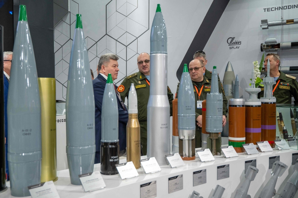 Belarusian military officers view heavy rounds on display at the Russian pavilion during the International Defence Exhibtion (IDEX) at the Abu Dhabi International Exhibition Centre on February 20, 2023. (Photo by Ryan LIM / AFP)