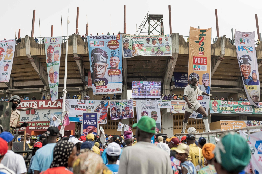 People enter Teslim Balogun Stadium during a rally for the All Progressives Congress (APC) presidential candidate Bola Ahmed Tinubu in Lagos on February 21, 2023 ahead of the Nigerian presidential election scheduled for February 25, 2023. (Photo by Patrick Meinhardt / AFP)