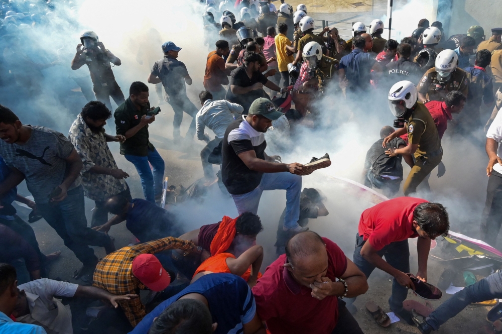 Police fire tear gas to disperse activists of the opposition National People痴 Power (NPP) party during a protest held to urge the government to hold local council election as scheduled in Colombo on February 26, 2023. (Photo by ISHARA S. KODIKARA / AFP)
