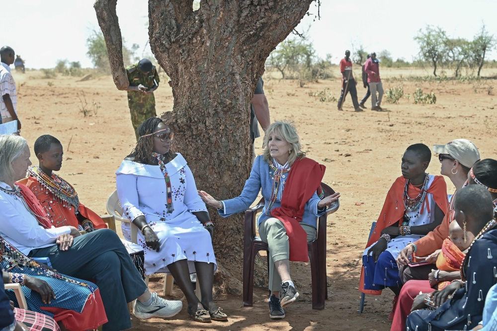 US First Lady Jill Biden interacts with women from the Maasai community at Loseti village in Kajiado county, Kenya, on February 26, 2023 where she heard about the impoverishing impact of drought to the herder community during the third day of her visit to Kenya where she toured a drought response site to highlight the impacts of drought on communities. (Photo by Tony Karumba / AFP)