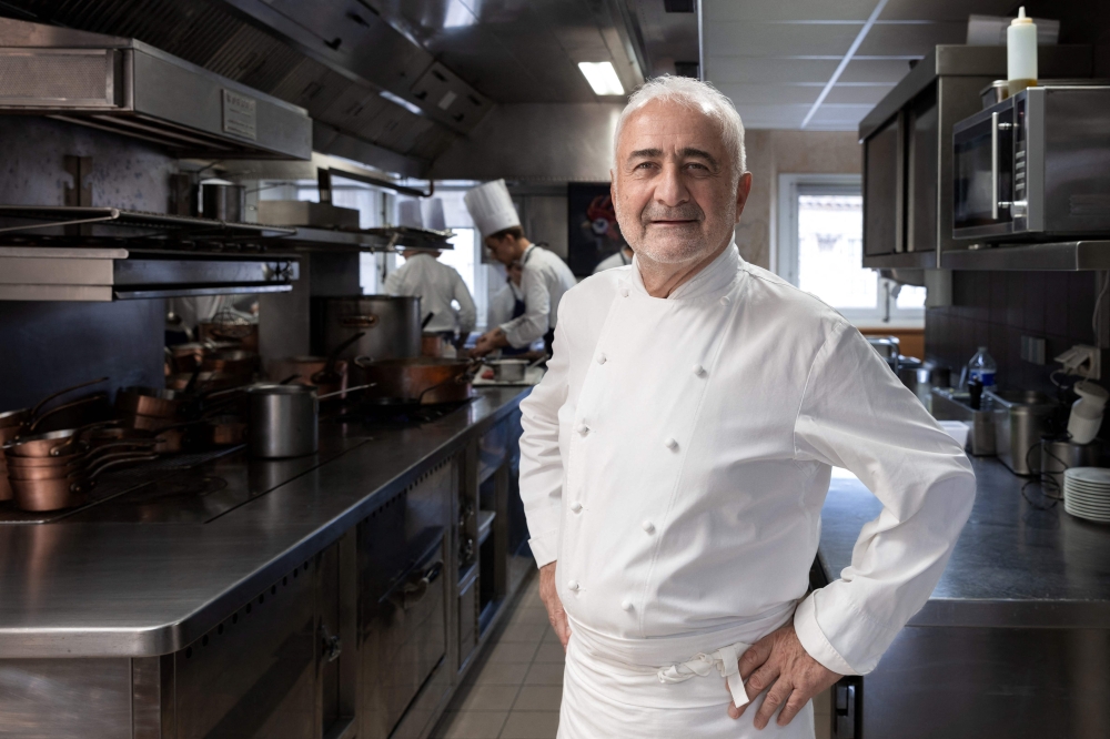 In this file photo taken on November 29, 2022 French chef Guy Savoy poses during a photo session in his restaurant in Paris. (Photo by JOEL SAGET / AFP)
