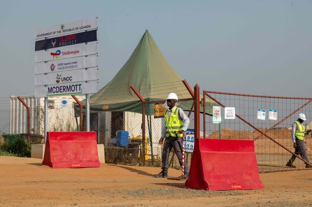 Guards work at TotalEnergies' central processing facility construction in Buliisa, Uganda on February 20, 2023. (Photo by BADRU KATUMBA / AFP)