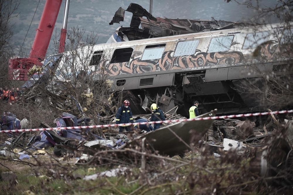 Police and emergency crew search the debris of a crushed wagon after a train accident in the Tempi Valley near Larisa, Greece, March 1, 2023. Photo by Sakis MITROLIDIS / AFP