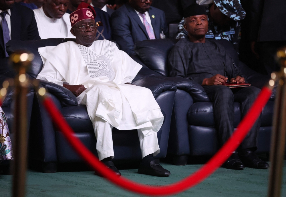 Nigeria President-elect, Bola Tinubu (L) and vice-president of Nigeria, Yemi Osinbajo (R), look on during the presentation of the certificate of return to the President-elect by the Independent National Electoral Commission (INEC) in Abuja on March 1, 2023. (Photo by KOLA SULAIMON / AFP)