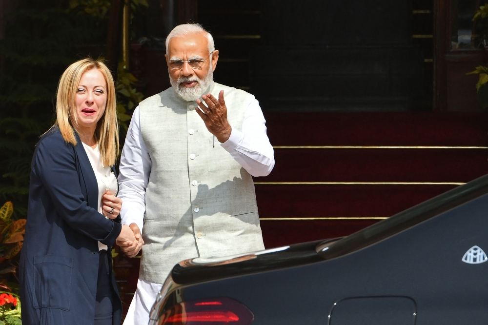 India's Prime Minister Narendra Modi greets his Italian counterpart Giorgia Meloni upon her arrival for a meeting at the Hyderabad House in New Delhi on March 2, 2023. (AFP)